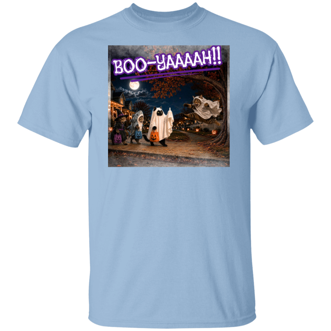 A light blue short-sleeve t-shirt with a colorful graphic print of a Halloween night scene featuring cat's going trick or treating, and a cat jumping out from behind a tree, dressed as a ghost, to scare the other cats, and the text 'BOO - YAAAAAH!!' in purple neon, worn by a model. The cat that was the intended target is holding up it's middle finger under it's costume as an automatic response to the annoying ghost.