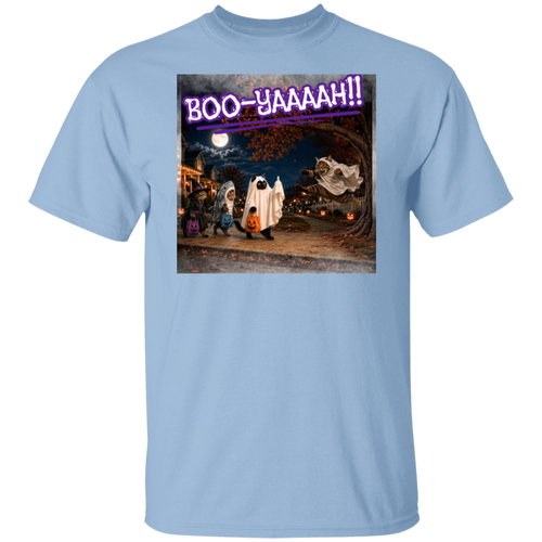 A light blue short-sleeve t-shirt with a colorful graphic print of a Halloween night scene featuring cat's going trick or treating, and a cat jumping out from behind a tree, dressed as a ghost, to scare the other cats, and the text 'BOO - YAAAAAH!!' in purple neon, worn by a model. The cat that was the intended target is holding up it's middle finger under it's costume as an automatic response to the annoying ghost.