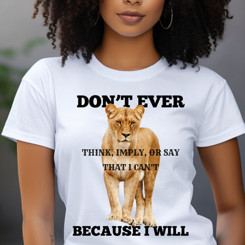 A woman wearing a white graphic t-shirt with a lion print and the text 'DON'T EVER THINK, IMPLY, OR SAY THAT I CAN'T BECAUSE I WILL'.