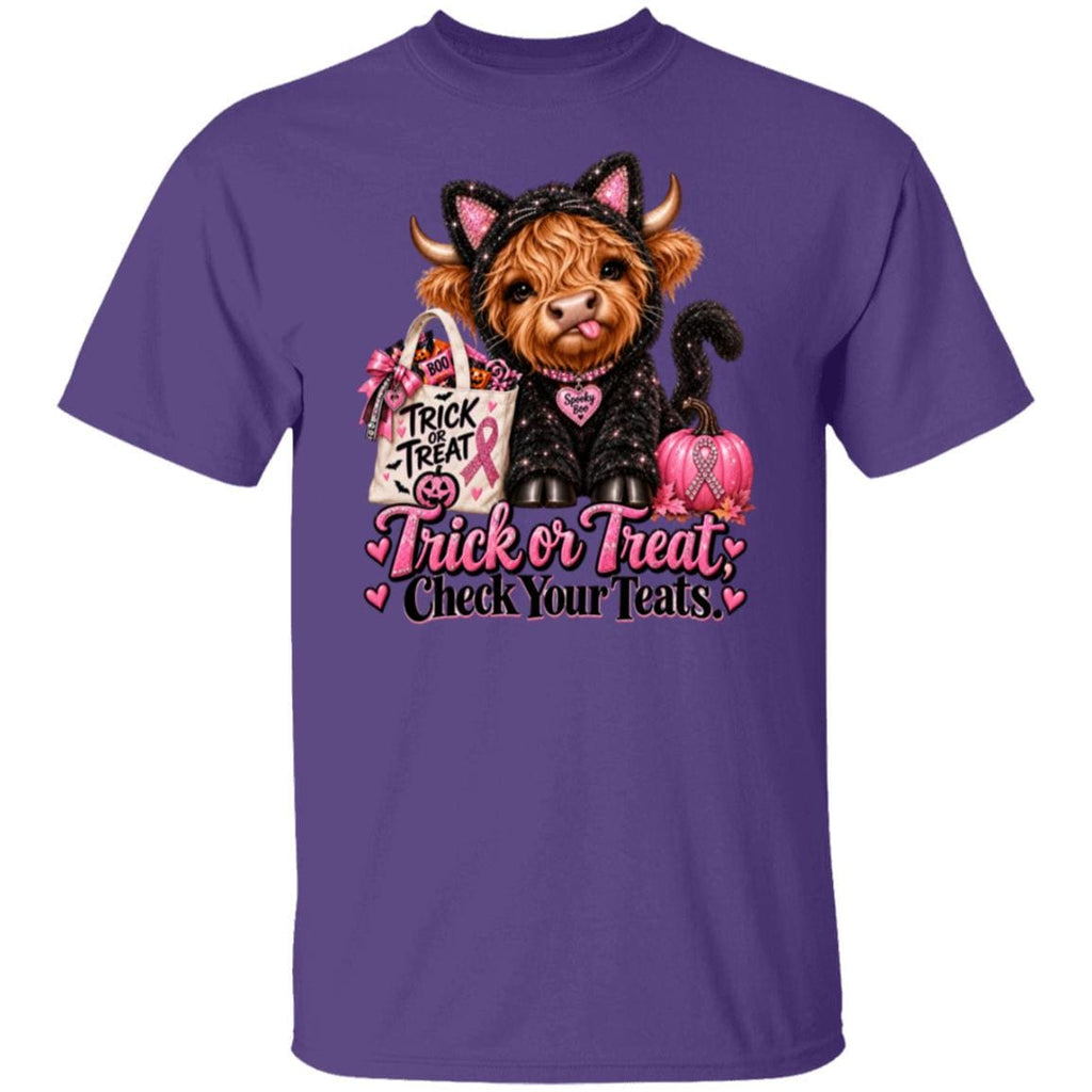 A purple short-sleeve crewneck t-shirt featuring a graphic of a Scottish highland cow dressed in a black cat costume with pink ears, holding a pink and white 'Trick or Treat' bag and a pink pumpkin, with the text 'Trick or Treat Check Your Teats' printed below.