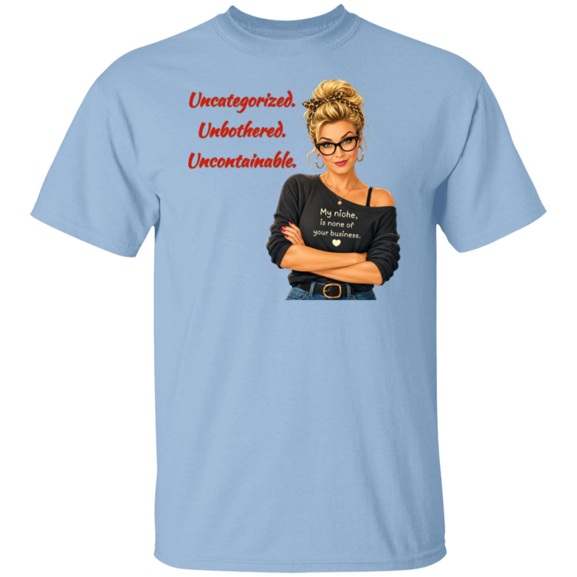 A light blue short-sleeve t-shirt with a graphic print on the front. The graphic features a retro-style illustration of a blonde woman in glasses wearing a black off-the-shoulder shirt with the text  'My niche, is none of your business.", along with "Uncategorized", "Unbothered", "Uncontainable" written in red letters.