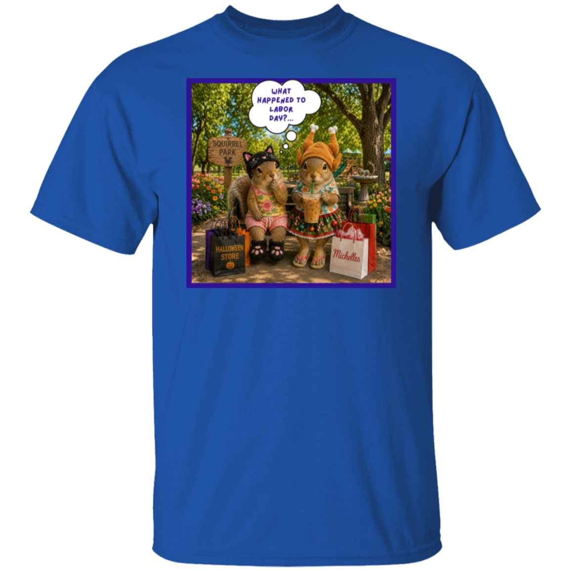 A royal blue short-sleeve crewneck t-shirt featuring a square graphic print on the chest. The print shows two fashionable squirrel besties are taking a well-deserved shopping break at Squirrel Park. One is clearly ready for spooky season in her cat costume, while the other has apparently skipped straight past fall and landed somewhere between Thanksgiving and Christmas—iced coffee in hand, naturally. Surrounded by shopping bags and seasonal chaos, one squirrel wonders "What Happened to Labor Day?".