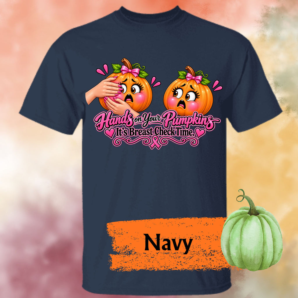 A navy short-sleeve graphic t-shirt, featuring a humorous  important reminder with this funny Breast Cancer Awareness Shirt, created for women who like their Pink October message with a little sass. This playful Breast Cancer Awareness Halloween design features two adorably horrified pumpkins, pink bows, pink accents, a breast cancer awareness ribbon and the cheeky reminder: “Hands on Your Pumpkins — It's Breast Check Time!” while what hands are squeezing the one pumpkin for lumpkins.