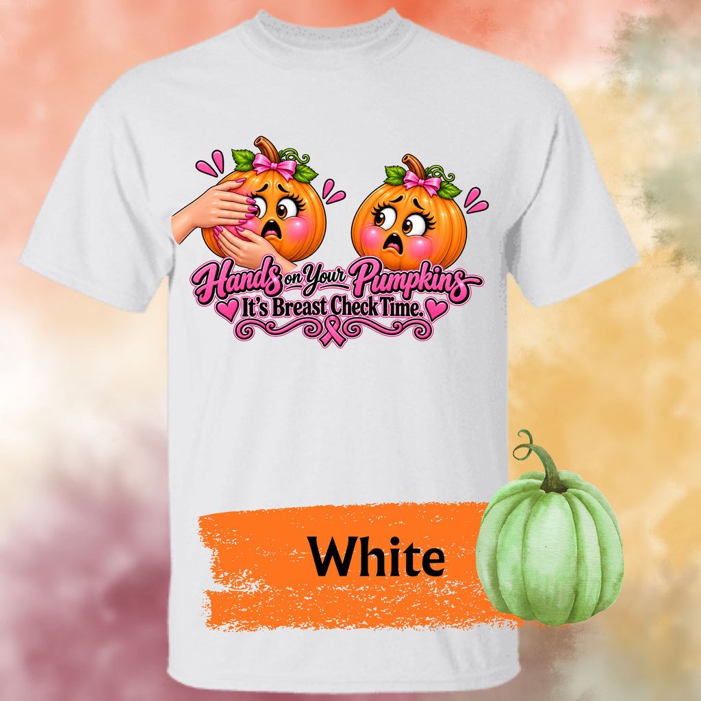 A white short-sleeve graphic t-shirt, featuring a humorous  important reminder with this funny Breast Cancer Awareness Shirt, created for women who like their Pink October message with a little sass. This playful Breast Cancer Awareness Halloween design features two adorably horrified pumpkins, pink bows, pink accents, a breast cancer awareness ribbon and the cheeky reminder: “Hands on Your Pumpkins — It's Breast Check Time!” while what hands are squeezing the one pumpkin for lumpkins.