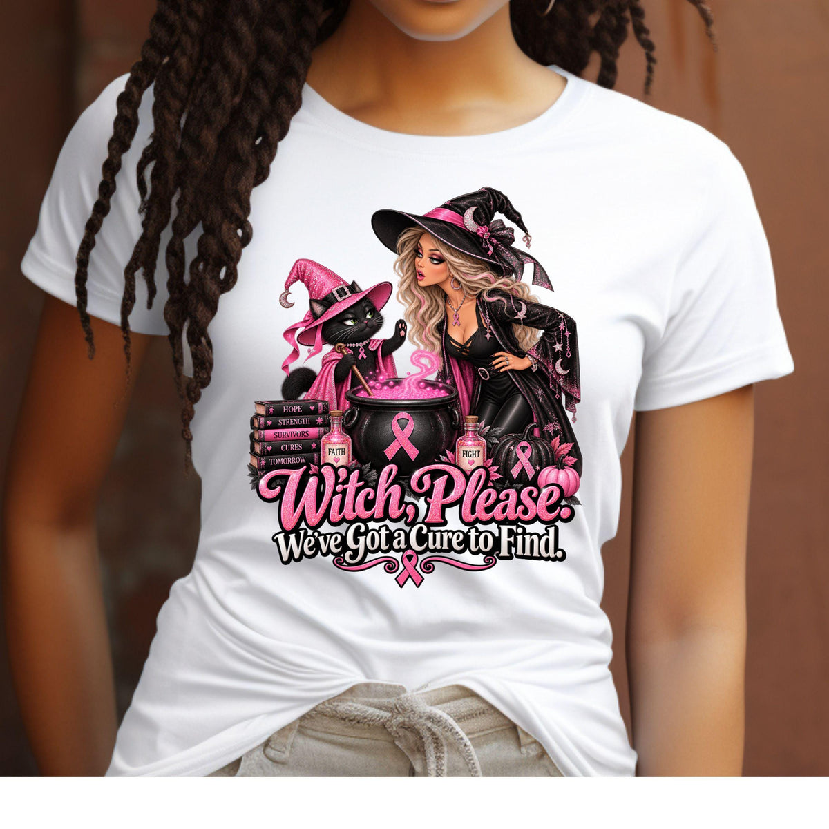 A model wearing a white short sleeved t-shirt with a design featuring a glamorous witch and her sassy black-cat sidekick brewing up something far more important than your average Halloween potion. Surrounded by sparkling pink breast cancer ribbons, pink pumpkins and bottles of Faith and Fight, their cauldron is bubbling with one mission: Finding a cure. The black cat is throwing up a hold it paw to the witch and the words say "Witch Please. We've got a cure to find."